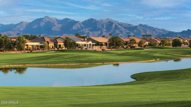 view of community with a water and mountain view and a lawn