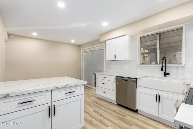 kitchen with backsplash, white cabinets, sink, light hardwood / wood-style flooring, and stainless steel dishwasher