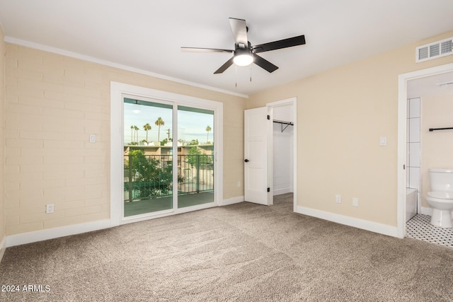 unfurnished bedroom with carpet flooring, connected bathroom, access to exterior, ceiling fan, and a closet