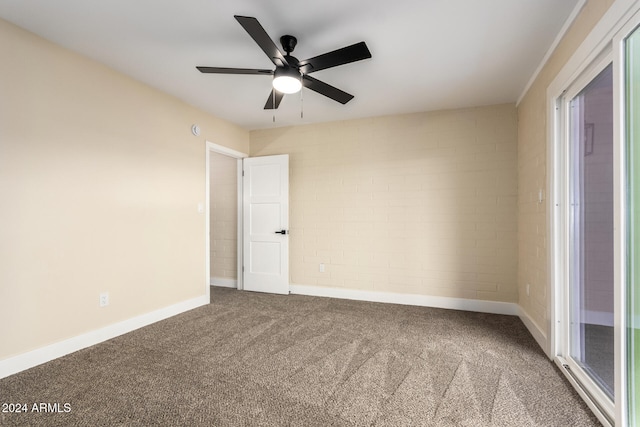 unfurnished room with ceiling fan and carpet