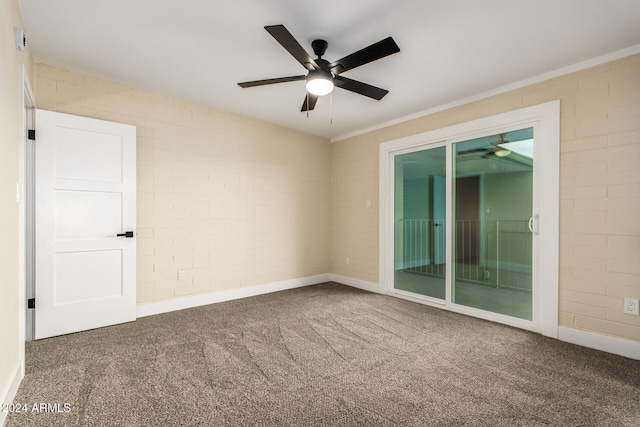 spare room with carpet flooring, ceiling fan, and brick wall