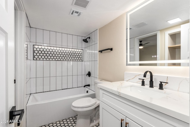 full bathroom with vanity, tiled shower / bath, tile patterned flooring, ceiling fan, and toilet