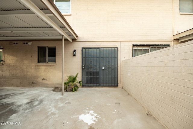 view of exterior entry with a patio area