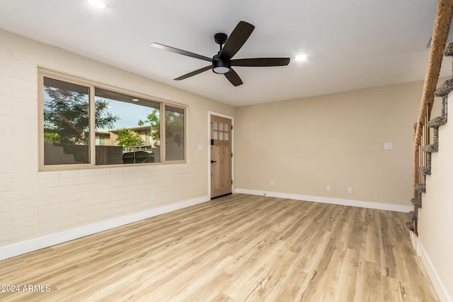 unfurnished room with ceiling fan and light wood-type flooring