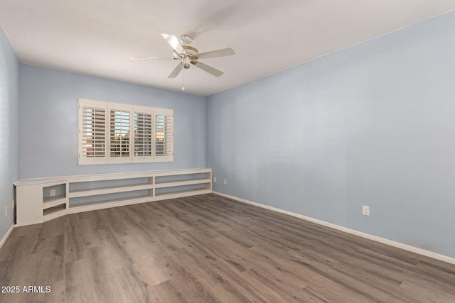 spare room with ceiling fan and hardwood / wood-style flooring