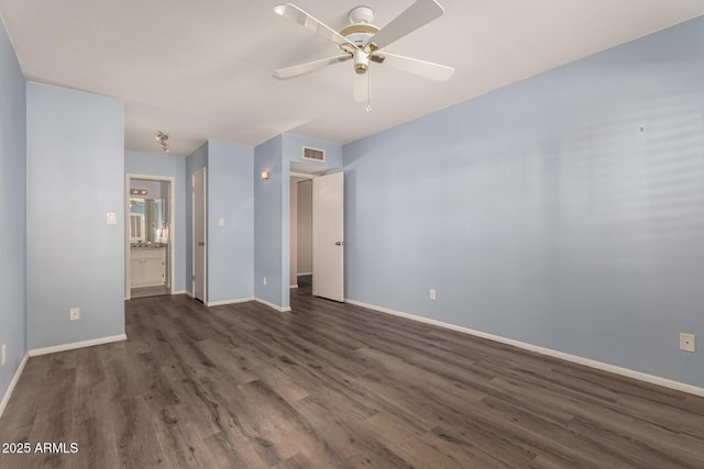 spare room with ceiling fan and dark hardwood / wood-style flooring