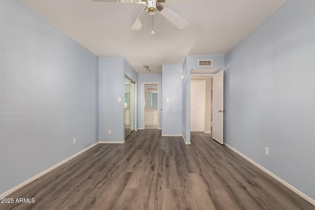 spare room with ceiling fan and dark hardwood / wood-style floors