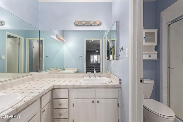 bathroom with vanity, toilet, and a shower with shower door