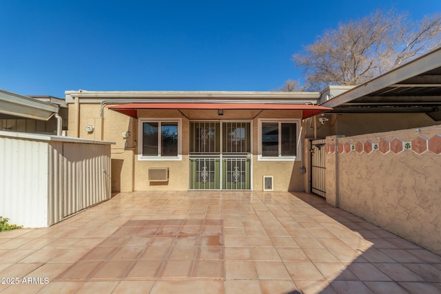 back of property with a patio