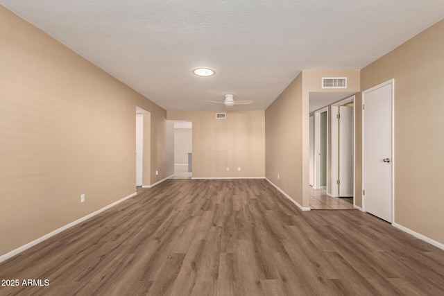 unfurnished room featuring ceiling fan and hardwood / wood-style flooring