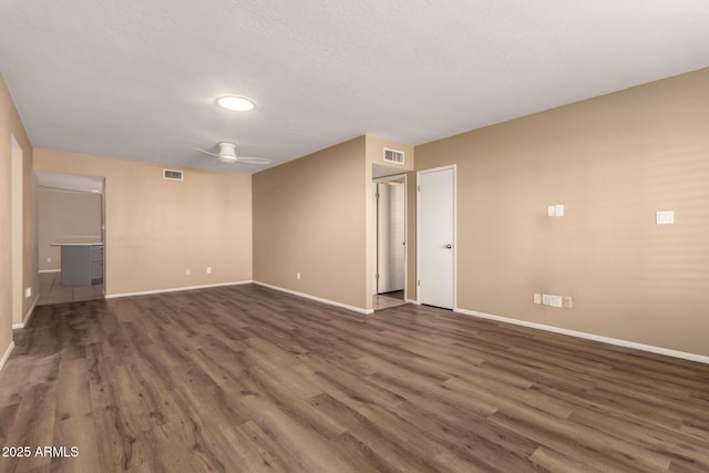 unfurnished room featuring dark hardwood / wood-style flooring and ceiling fan