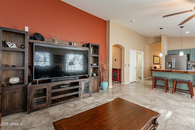 living room featuring high vaulted ceiling and ceiling fan