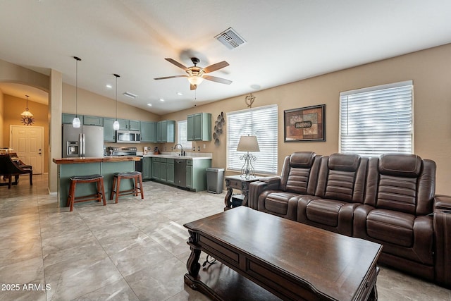 living room with lofted ceiling, sink, and ceiling fan