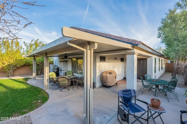 view of patio with ceiling fan and area for grilling