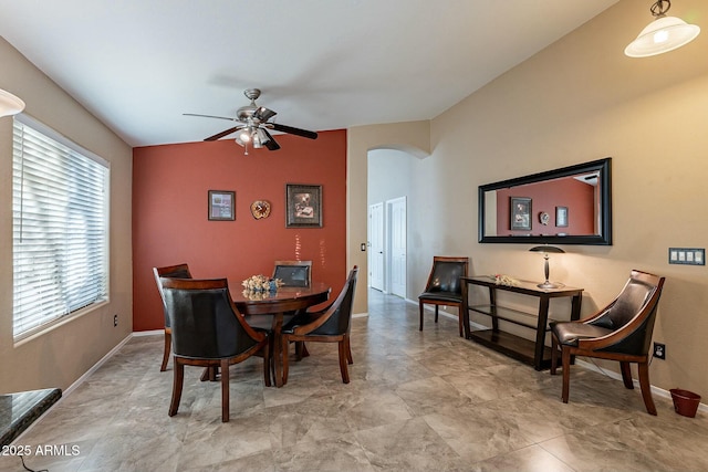 dining space featuring ceiling fan and lofted ceiling