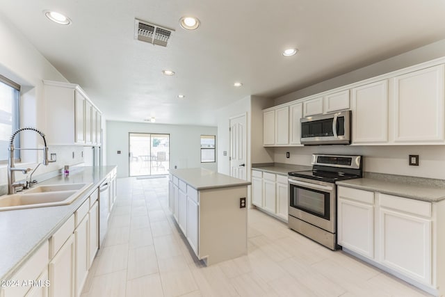 kitchen featuring plenty of natural light, sink, white cabinetry, and stainless steel appliances