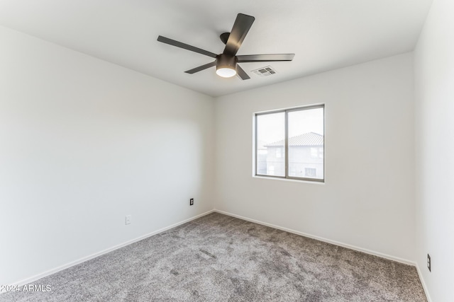 carpeted empty room featuring ceiling fan