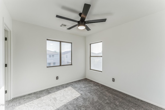 carpeted spare room featuring ceiling fan