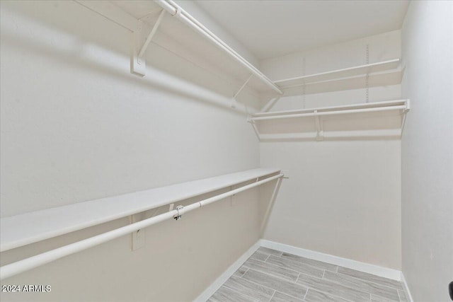 spacious closet with light wood-type flooring