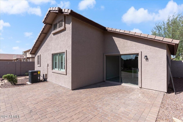 rear view of house with a patio and central AC unit