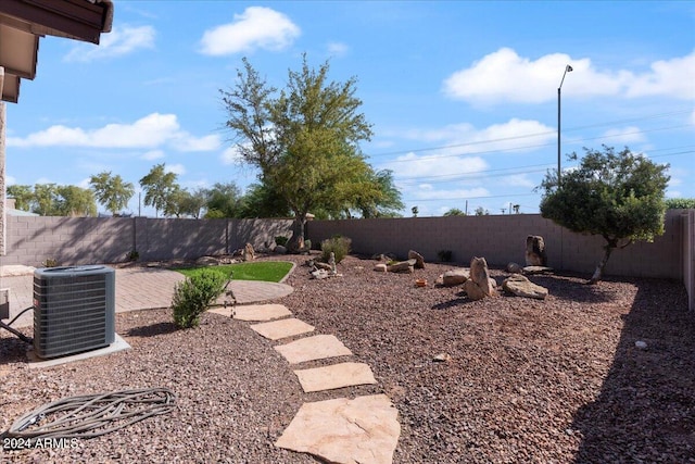 view of yard featuring a patio and central AC unit