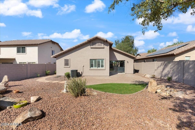 rear view of house featuring a patio and central AC