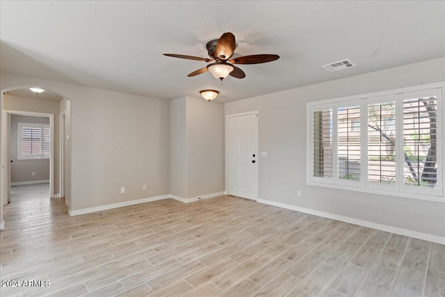 unfurnished room featuring ceiling fan, light hardwood / wood-style flooring, and a wealth of natural light