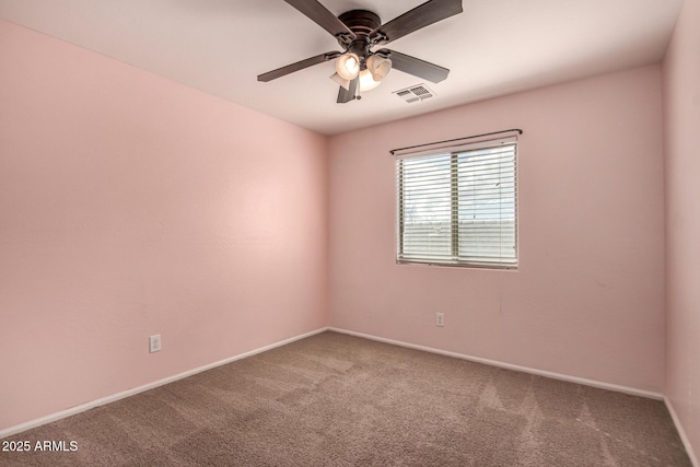 spare room with carpet floors and ceiling fan