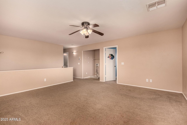 spare room featuring ceiling fan and carpet