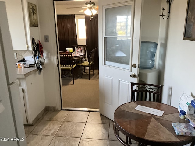 dining area with light tile patterned flooring and a ceiling fan