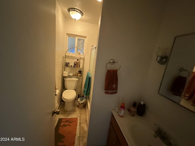 bathroom with toilet, tile patterned flooring, a shower, and vanity