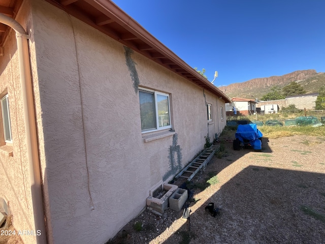 view of home's exterior featuring a mountain view and stucco siding