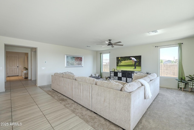 tiled living room with ceiling fan