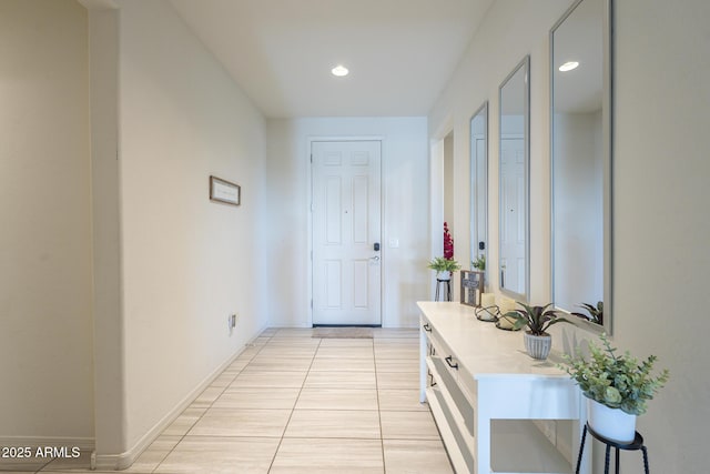 hall with light tile patterned floors