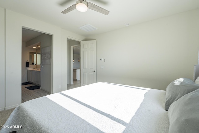 bedroom featuring ensuite bath and ceiling fan