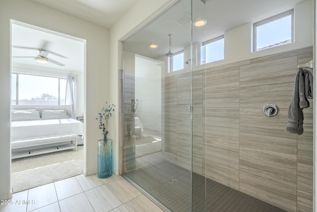 bathroom featuring ceiling fan, tile patterned floors, and tiled shower