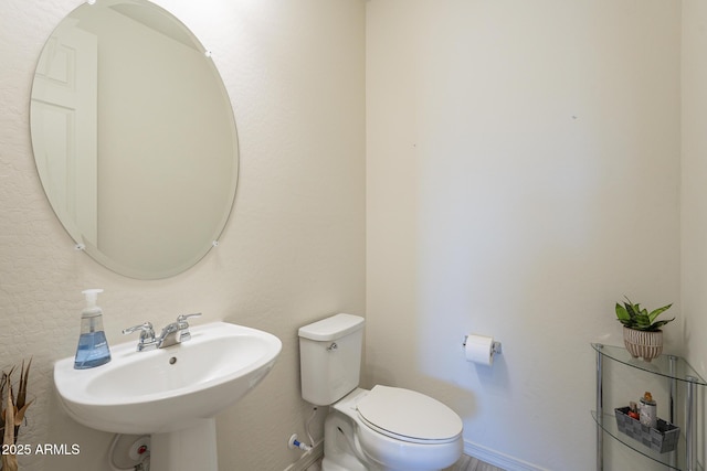 bathroom featuring toilet and sink