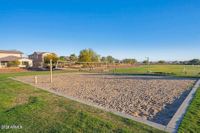 view of community featuring a lawn and volleyball court