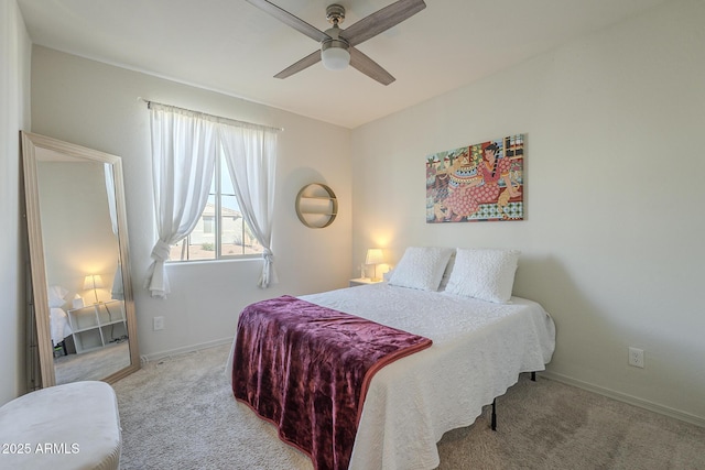 bedroom featuring ceiling fan and light carpet