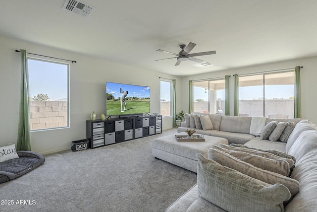 living room with ceiling fan and carpet floors