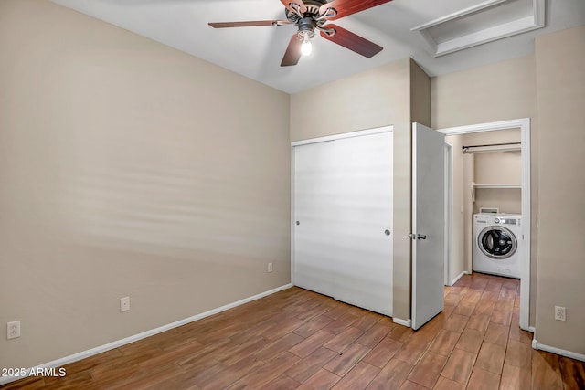 unfurnished bedroom with ceiling fan and washer / dryer