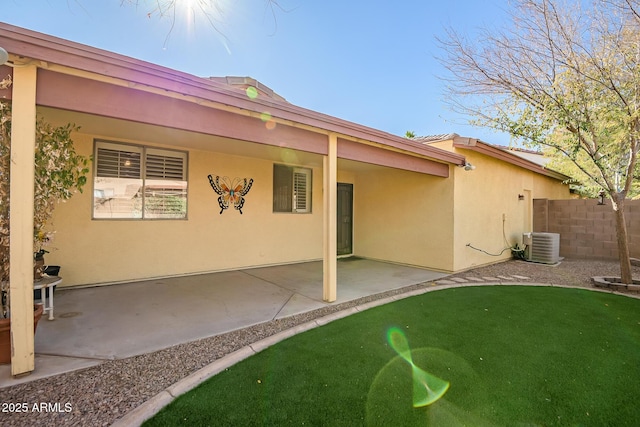 back of property with cooling unit and a patio area