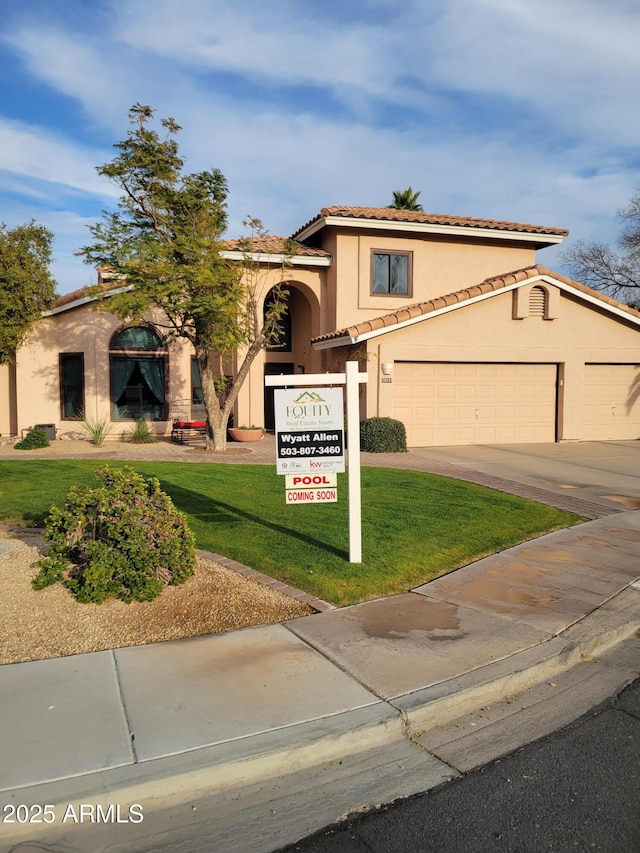 mediterranean / spanish home with a front yard