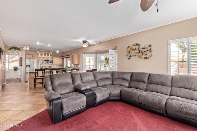 living room with light tile patterned floors and ceiling fan