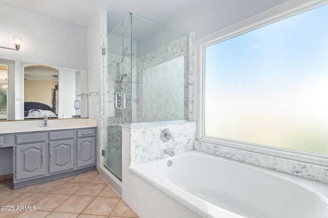 bathroom with vanity, tile patterned floors, and plus walk in shower