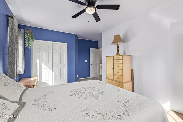 bedroom with ceiling fan and a closet