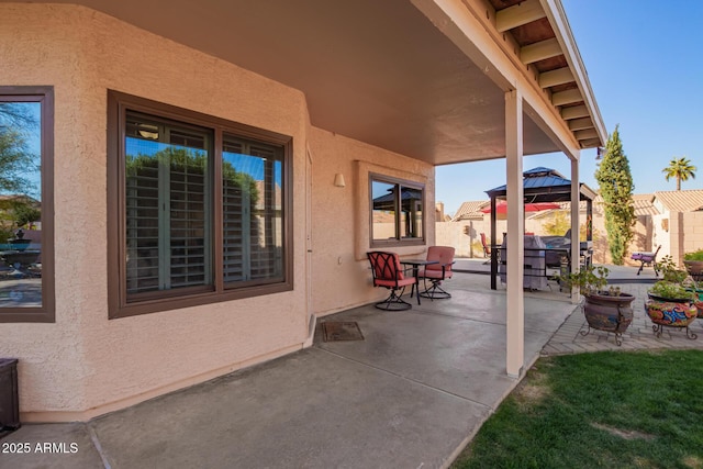 view of patio featuring a gazebo and a grill