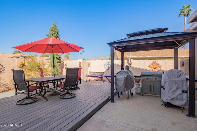 wooden deck with a gazebo and grilling area