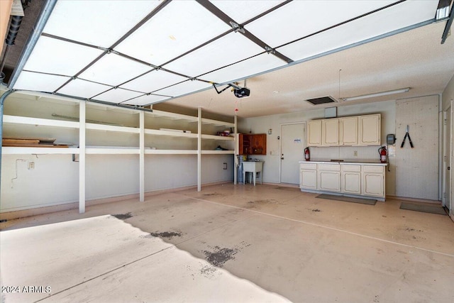 garage featuring a garage door opener and sink