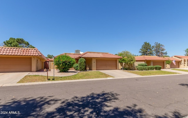 mediterranean / spanish-style house with a garage